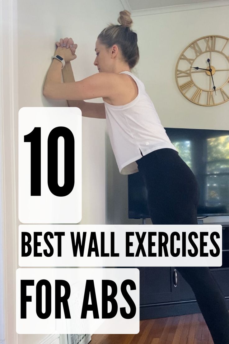 a woman is doing exercises on the wall