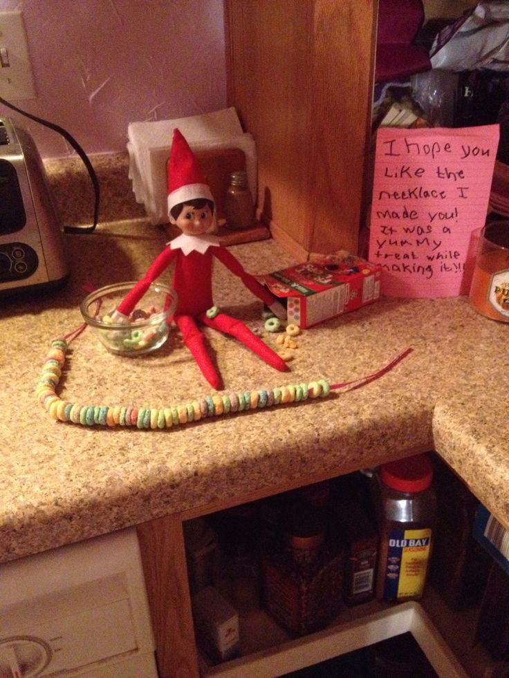 an elf is sitting on top of the counter in the kitchen with some food and condiments