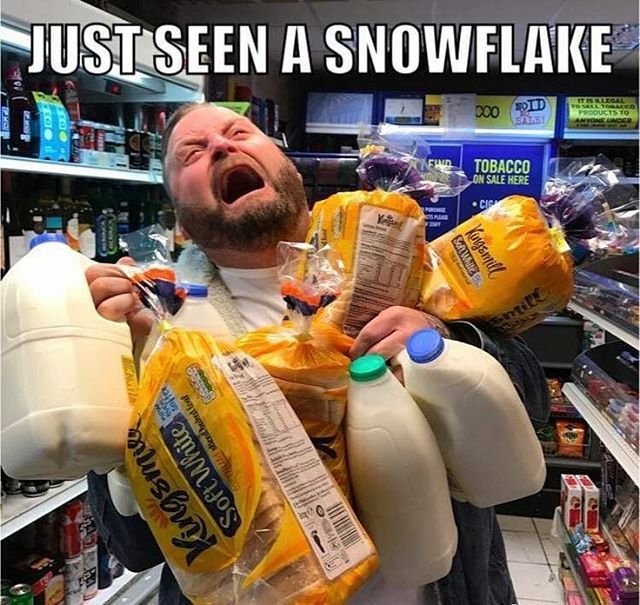 a man holding two bags of snowflake in his arms and yelling at the camera