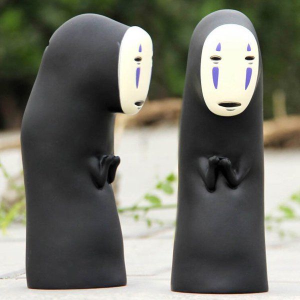 two black and white ghost dolls sitting next to each other