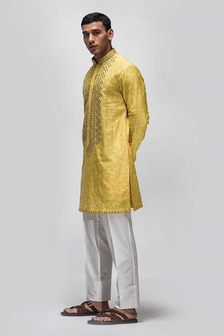 Yellow kurta with resham and thread work embroidery detailing crafted in chanderi silk. Comes with pant.
Components: 2
Pattern: Embroidery
Type Of Work: Resham and Mirror work
Neckline: Mandarin Collar
Sleeve Type: Full
Fabric: Chanderi Silk
Color: Yellow
Other Details: 
Tonal resham embroidery
Approx Weight (in kgs): 0.84
Occasion: Mehendi and Puja - Aza Fashions Mirror Work Kurta, Yellow Mirror, Yellow Kurta, Yellow Mirrors, Resham Embroidery, Kurta Set For Men, Embroidery Detailing, Silk Kurta, Pattern Embroidery