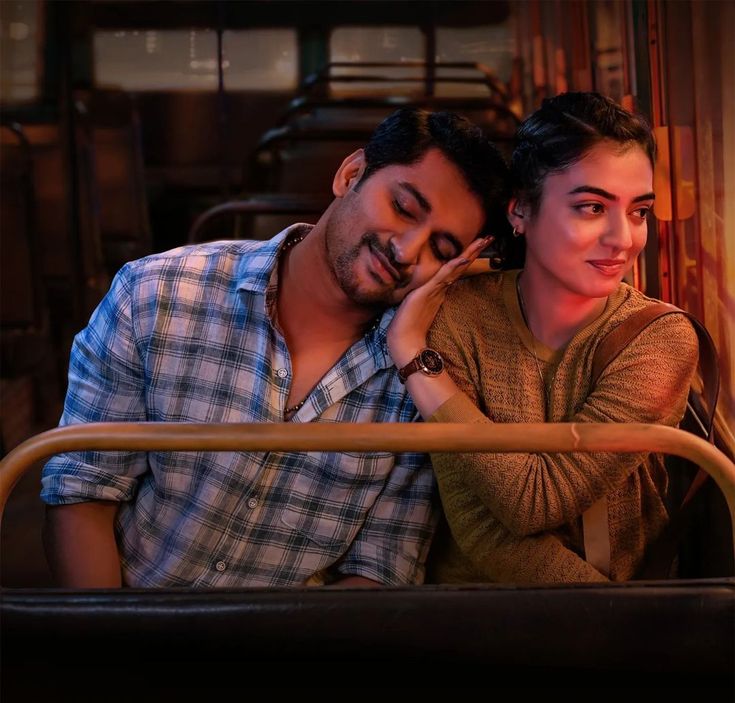 a man and woman sitting next to each other on a train car with their eyes closed