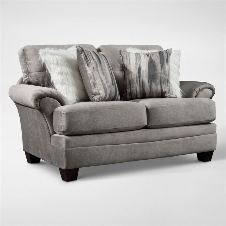 a gray couch with pillows on top of it