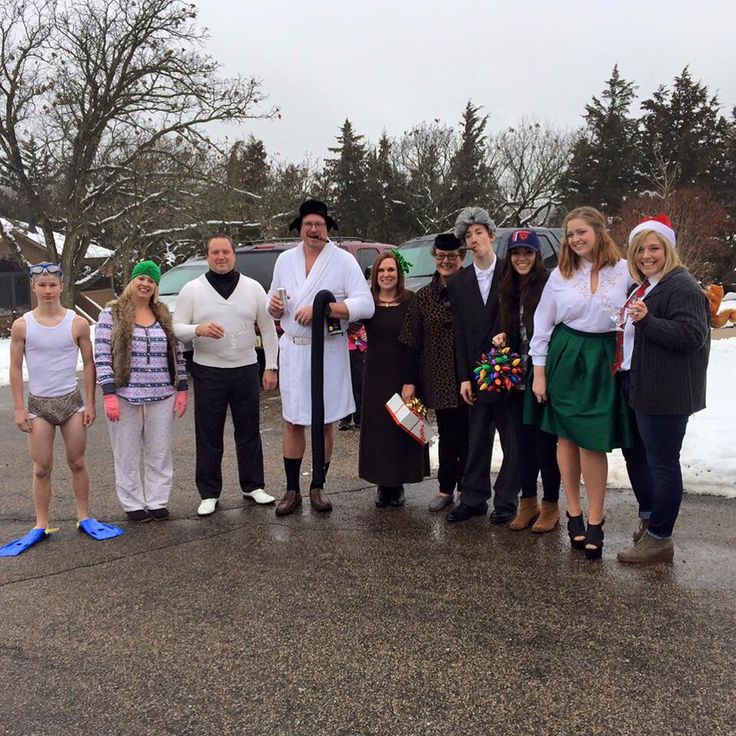 a group of people dressed up in costumes posing for a photo on a snowy day