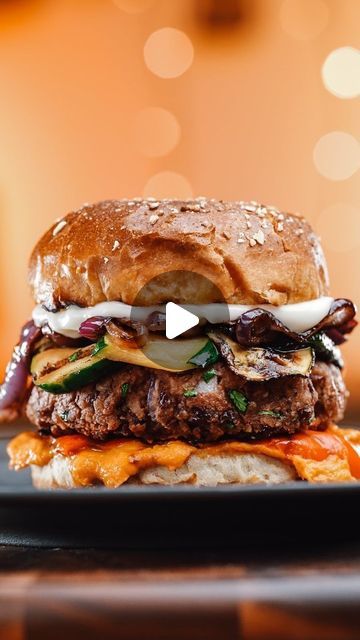 a hamburger sitting on top of a black plate