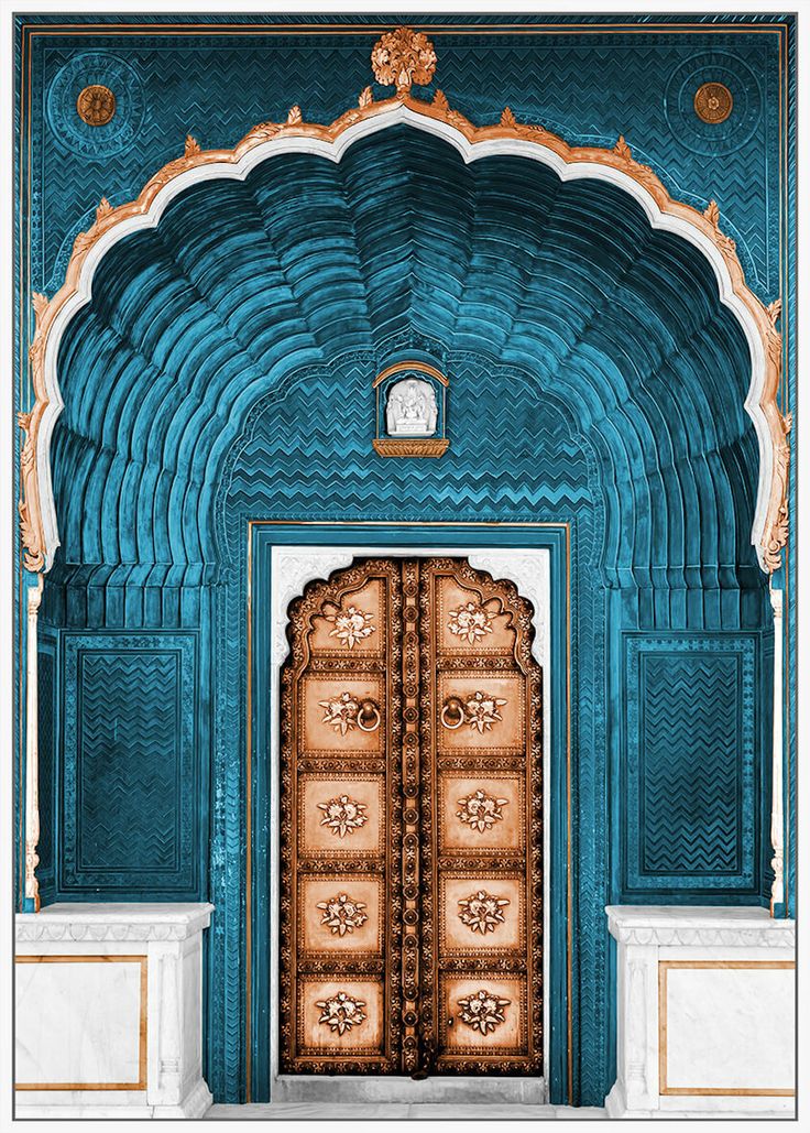 an ornate doorway with blue walls and gold trimmings, decorated with intricate carvings