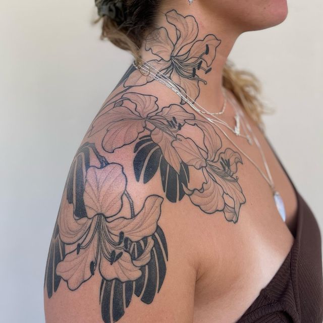 a woman with tattoos on her neck and shoulder