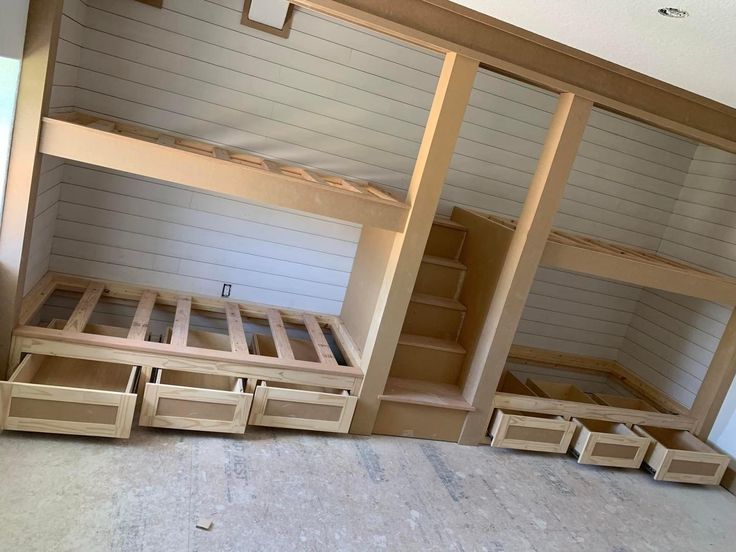 bunk beds with drawers in an unfinished room