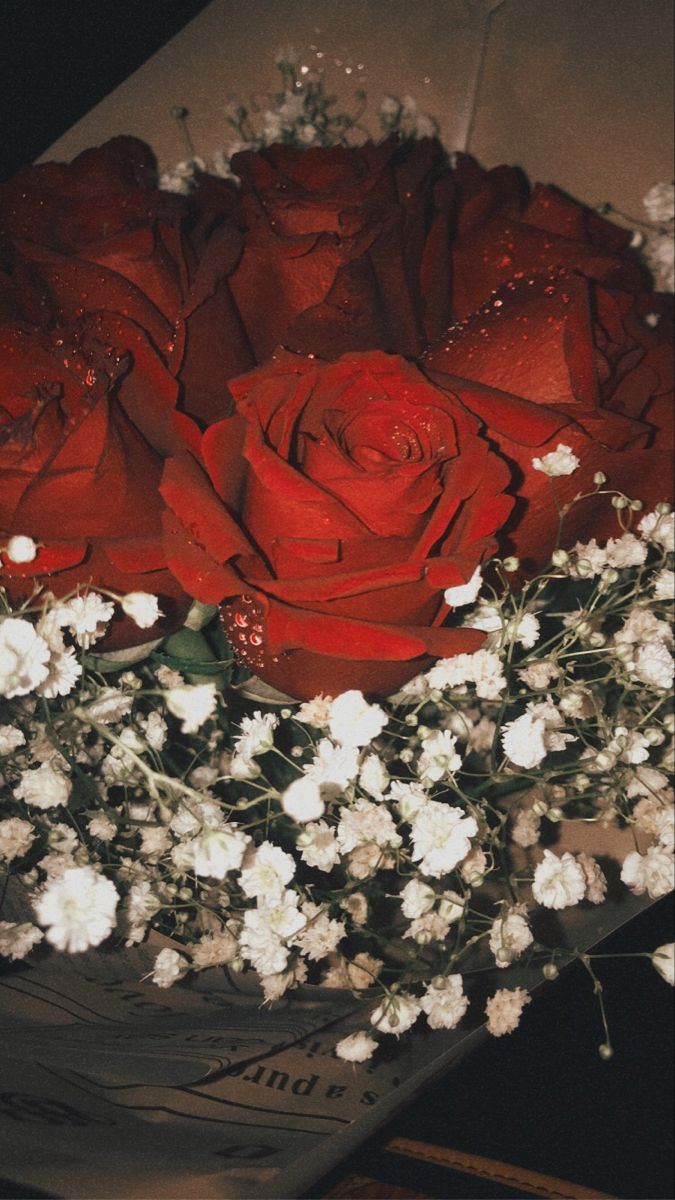 a bouquet of red roses and white flowers