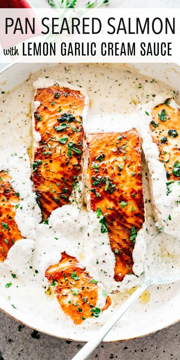 pan seared salmon with lemon garlic cream sauce in a white bowl on a table