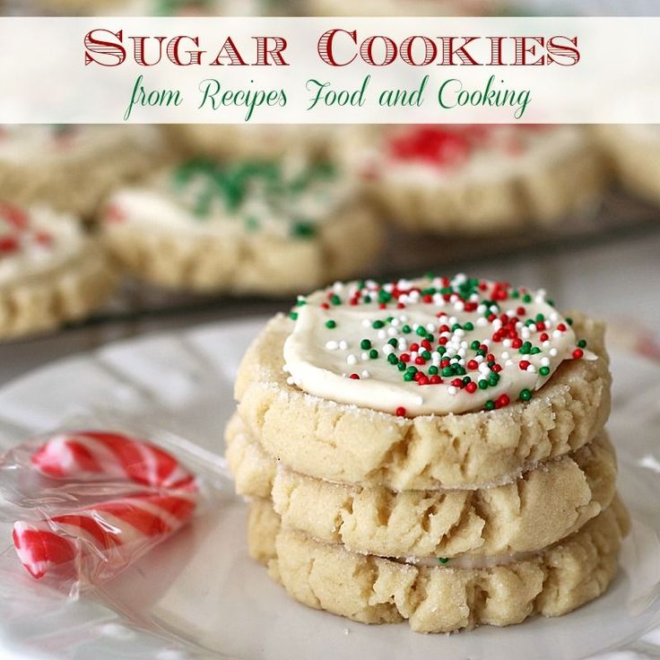 sugar cookies with white icing and sprinkles on a plate