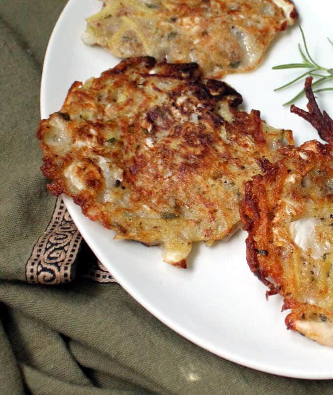 some food is on a white plate with green garnish and sprigs