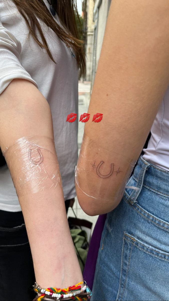 two people with tattoos on their arms