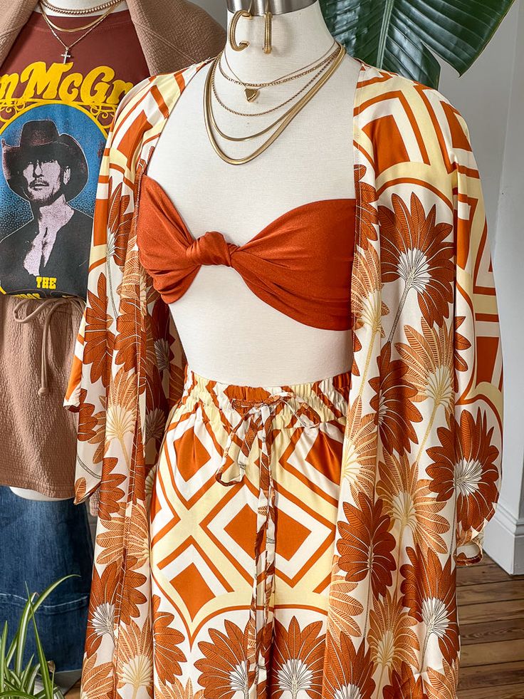 The Blair Sleeveless Tie Back Top his giving off sunny weather vacay vibes all day! This top has adjustable spaghetti straps and a tie back for ease of wear and a shiny mimosa colored fabric that pairs perfectly with the Hawaiian Sunset Kimono and the Hawaiian Sunset Wide Leg Pant for a flirty fun day into night look. Model is 5'10" wearing a size Medium 82% Nylon - 18% Spandex Hand Wash Cold - Do Not Bleach - Hang to Dry Hawaiian Sunset, Vacay Vibes, Tie Back Top, Sunny Weather, Colored Fabric, Wide Leg Pant, Fun Day, Night Looks, Mimosa