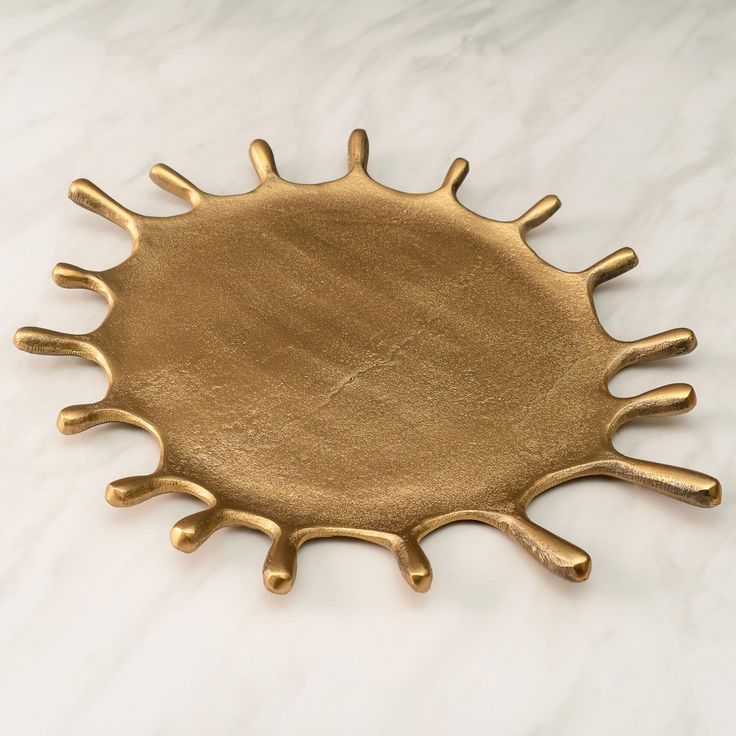 a gold plate sitting on top of a white counter