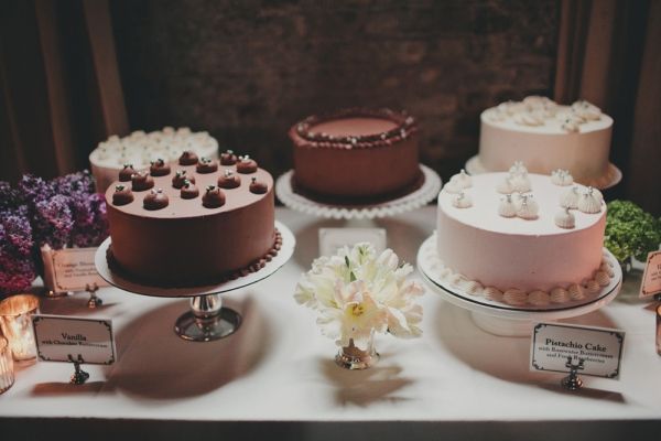 a table topped with lots of different types of cakes