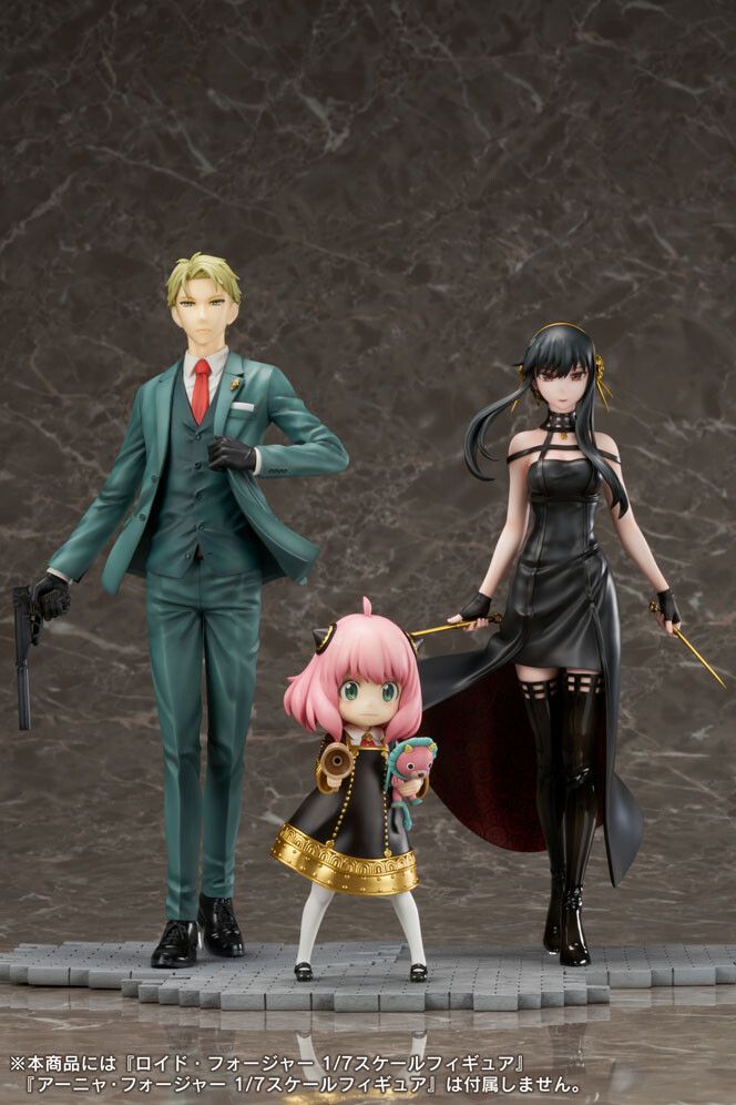 two anime figurines are posed next to each other