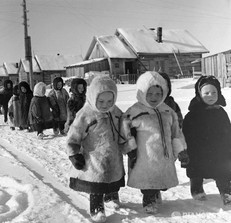 black and white photograph of children in the snow