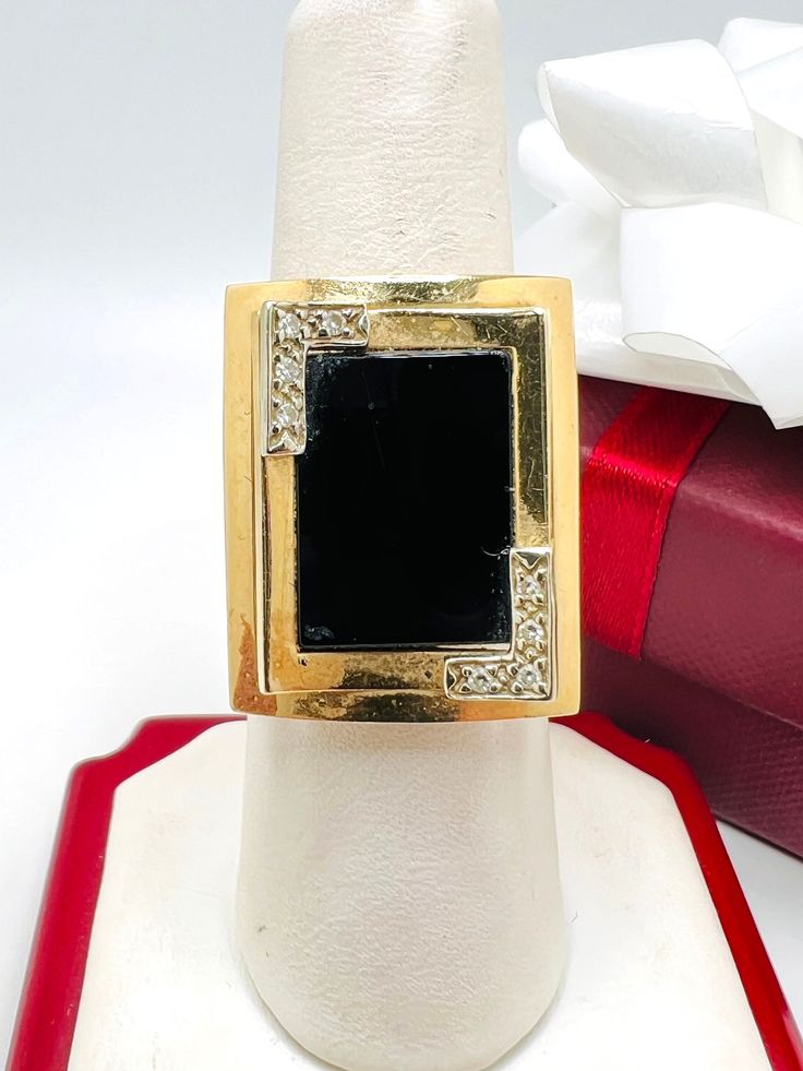 Vintage 14K Yellow Gold Black Onyx & Diamond 0.04ct Ring Size 6.75 A perfect gift for your loved one for any special occasion or holiday! Total Ring Weight: 6.43g Ring Length: 25.58mm Ring Width: 19.81mm Gemstone: Diamond, Star Sapphire Total Diamond: 0.06ct A perfect gift for your loved one for any special occasion or holiday! Total Ring Weight: 6.72g Ring Length: 23.30mm Ring Width: 20.20mm Gemstone: Diamond, Black Onyx Total Diamond: 0.04ct Item will be placed into a gift box. * Classic Black Diamond Ring As A Gift, Classic Black Diamond Ring Gift, Classic Black Diamond Ring For Gift, Black Diamond Rings For Formal Occasions, Black Enamel Diamond Jewelry For Anniversary, Anniversary Rings With Black Enamel And Diamond, Formal Black Diamond Ring With Diamond Accents, Black 14k Stamped Jewelry As Gift, Black 14k Stamped Jewelry For Gift