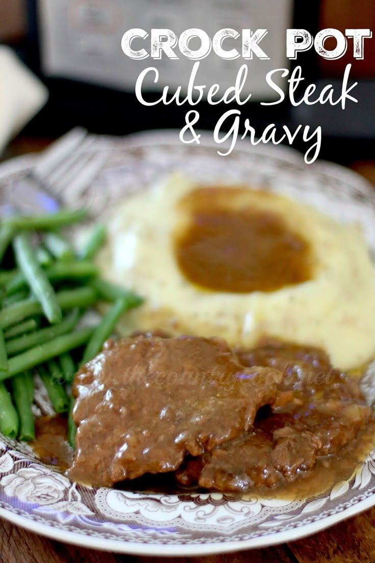 crock pot cubed steak and gravy on a plate with green beans