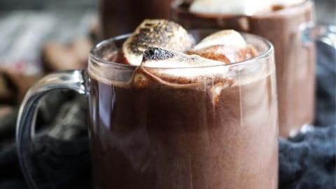 two mugs filled with hot chocolate and marshmallows