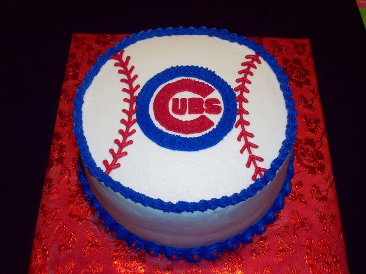 a cake decorated with the chicago cubs logo on top of a red and white tablecloth