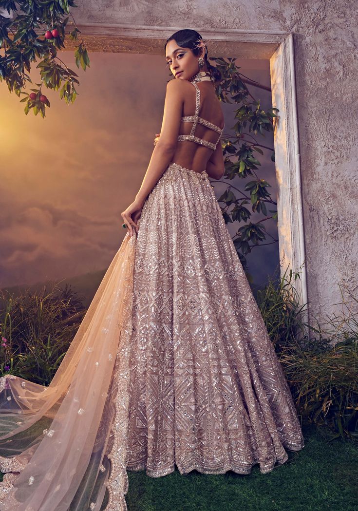 Editors Note Elevate your style with our taupe organza lehenga, adorned with exquisite hand-embroidery, including ornamental sequences, japanese bugle beads, and shimmering stones. Paired with a tulle scallop dupatta and a stylish blouse, this ensemble exudes timeless elegance. Scallop Dupatta, Strappy Blouse, Jacket Lehenga, Organza Lehenga, Padded Blouse, Embroidered Lehenga, Lehenga Saree, Sharara Set, Stylish Blouse