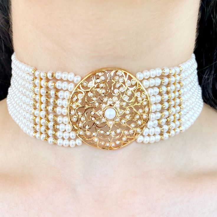 Handcrafted to perfection, this pearl choker inspired from the edwardian era of jewellery is made in 22ct hallmarked gold. Its a versatile piece of jewellery that can be paired with western, indo-western as well as traditional indian outfits. The choker weighs 52.19 GMs including 32.50 GMs of stringing pearls. The earrings weigh 6.24 GMs Price Breakup Summary Component Rupees % of Total 22k Gold 136,386 74.7% Stones & Beads 16,368 9.0% Making Charges 24,549 13.4% Taxes (GST) 5,319 2.9% Total 182,623 100.0% View Detailed Price Breakup Traditional Gold Pearl Necklace For Formal Occasions, Elegant Gold Plated Kundan Necklace For Ceremonial Occasions, Elegant Pearl Necklace With Tilla As A Gift, Elegant Tilla Pearl Necklace Gift, Elegant Gold Choker For Festive Occasion, Formal Festive Yellow Gold Pearl Necklace, Ceremonial Gold Pearl Necklace, Gold Pearl Necklace For Ceremonial Occasions, Gold Pearl Necklace For Formal Festive Occasions