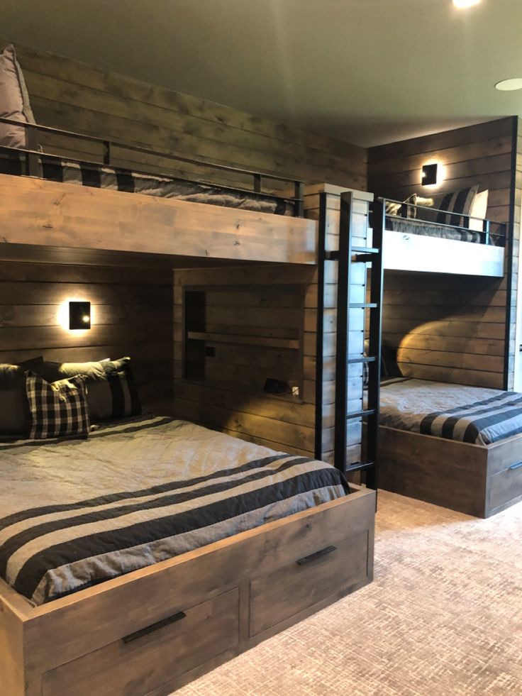 two bunk beds in a room with wooden walls and flooring, one is built into the wall