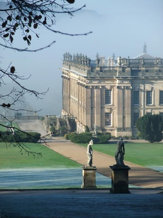 a large building with statues in front of it