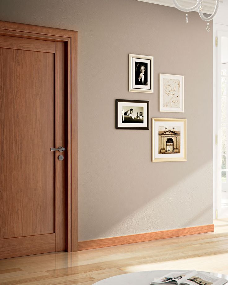 a living room with pictures on the wall and a coffee table in front of it