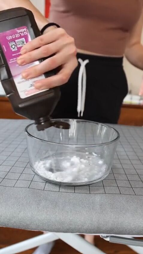 a woman is using an appliance to make ice cream in a glass bowl