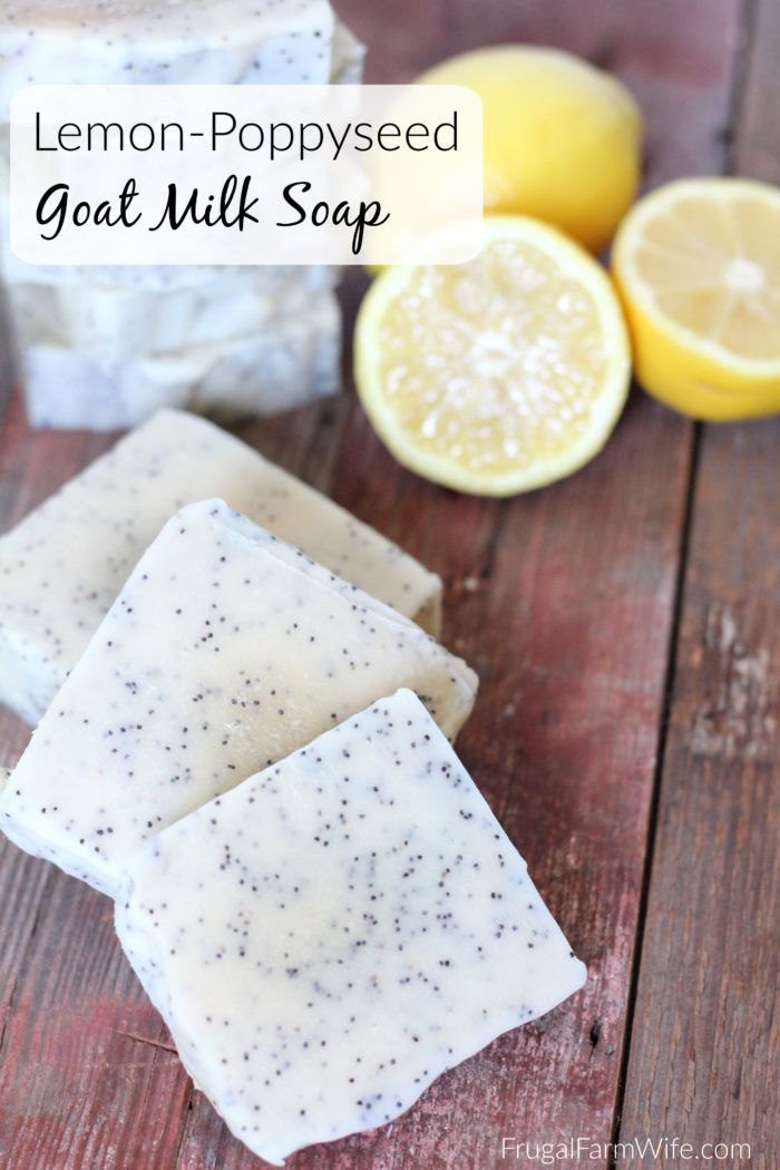 lemon - poppy seed goat milk soap bar on a wooden table with sliced lemons