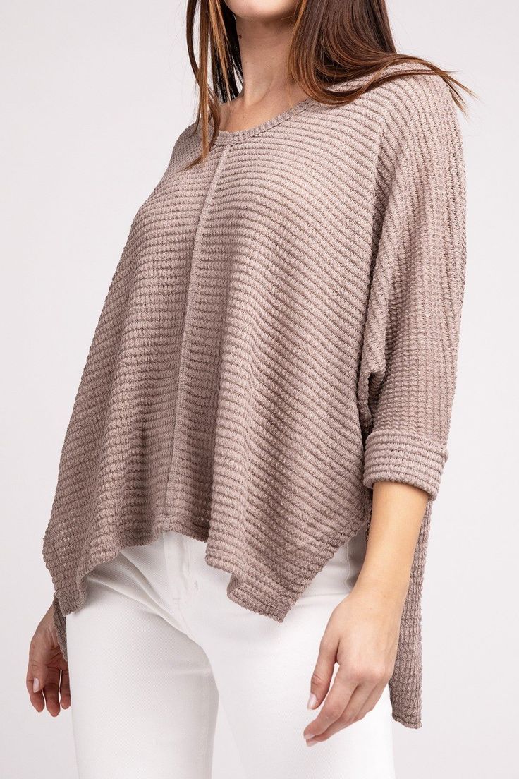 Elevate your spring wardrobe with our Zenana Waffle Knit 3/4 Sleeve Top. This lightweight top features a comfortable oversized fit. The V-neckline and hi-low hem add a touch of elegance, while the side slits provide extra comfort. Dress it up with white jeans or dress pants or keep it casual with denim shorts or jeans. You'll love the versatility of this waffle top! Neckline: V-neckline Features: Side Slits Fabric: Waffle knit texture Hemline: Hi-low hem Sheer: Semi-sheer Sleeve: 3/4 Sleeve Stre Textured Tops For Layering In Fall, Casual Textured Knit Top For Spring, Spring Textured Knit Top With Batwing Sleeves, Spring Batwing Sleeve Knit Top, Oversized Textured Knit Top For Layering, Oversized Waffle Knit Tops For Layering, Oversized Waffle Knit V-neck Tops, Textured Top For Spring Layering, Knit Sweater With 3/4 Sleeves