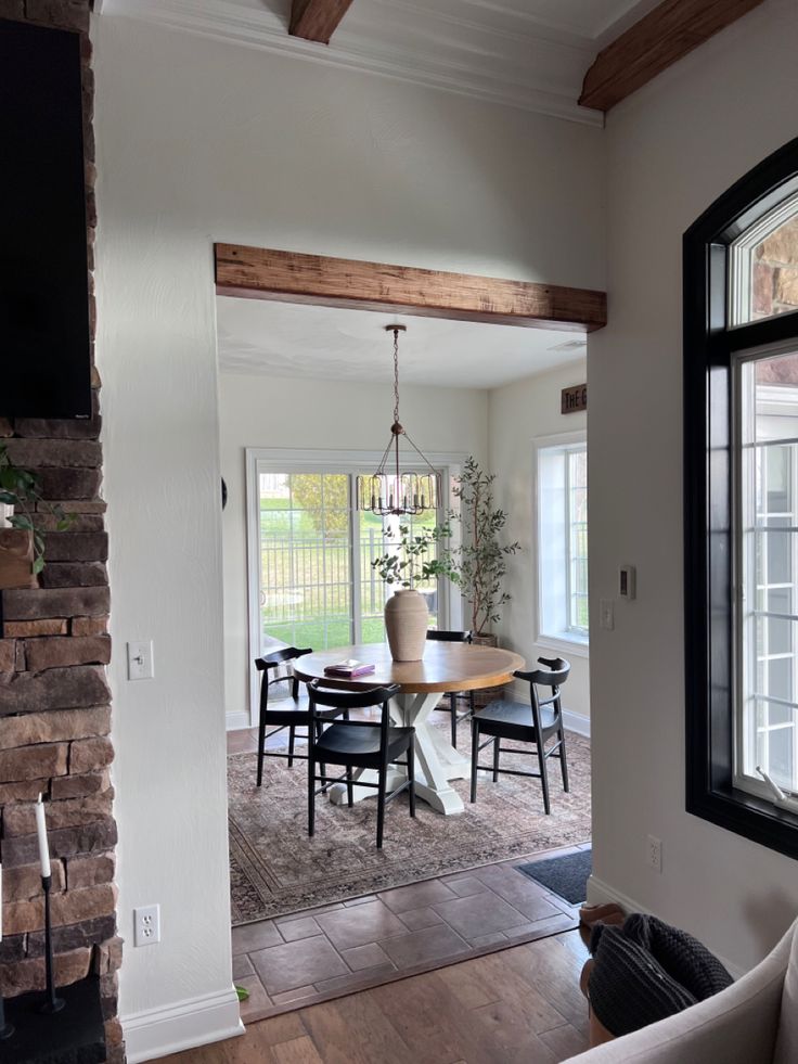 a living room with a fireplace and dining area