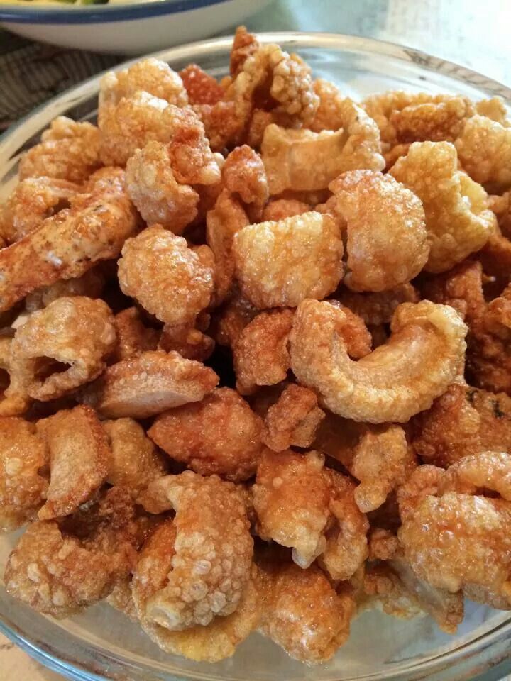 a bowl full of fried food sitting on top of a table