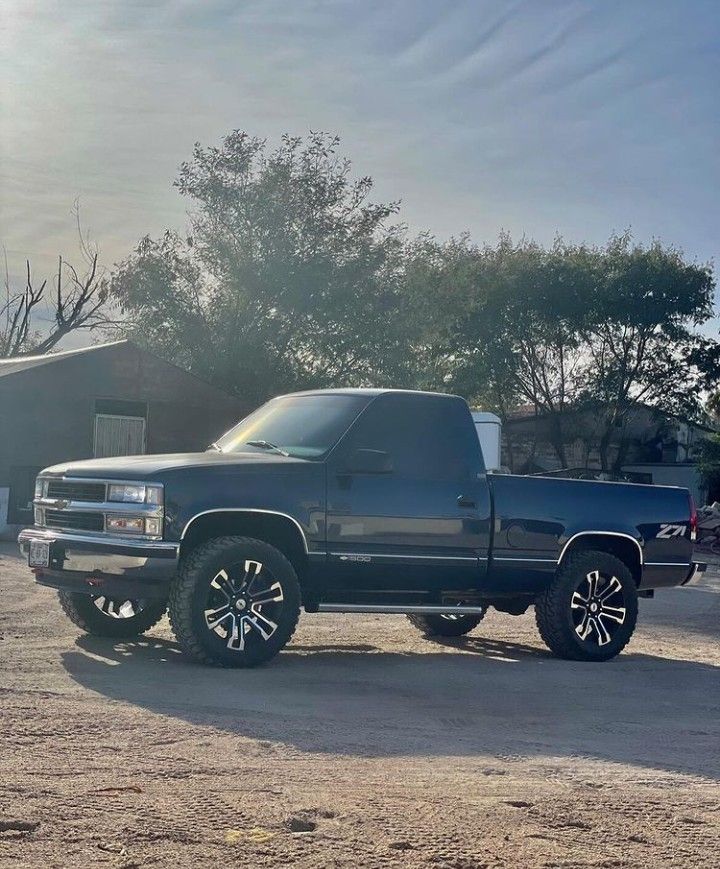 a black truck parked in a parking lot