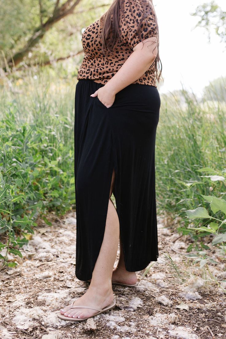 Effortlessly elegant and versatile, the Jocelyn Maxi Skirt is a must-have for any wardrobe. Crafted from a lightweight fabric, its maxi length and split sides provide a flowy and flattering fit. The elastic waist ensures comfort all day long. Embrace your inner goddess with this stunning skirt! The split sides measure 19"-20" from the top of the waistband. Fits true to size. Model is wearing a 1X and is 5'7". Size Chart Length Waist 1x 40" 38" 2x 40" 40" 3x 40" 44" *Measurements are approximate Casual Relaxed Maxi Skirt With Side Slits, Black Maxi Length Bottoms With Elastic Waistband, Casual Relaxed Fit Maxi Skirt With Side Slits, Casual Flowy Skirt With Side Slits, Black Split Hem Skirt For Summer, Chic Stretch Maxi Skirt With Split, Relaxed Fit Skirt With Side Slits And Split Hem, Black Stretch Skirt With Side Slits, Versatile Full Length Lined Maxi Skirt