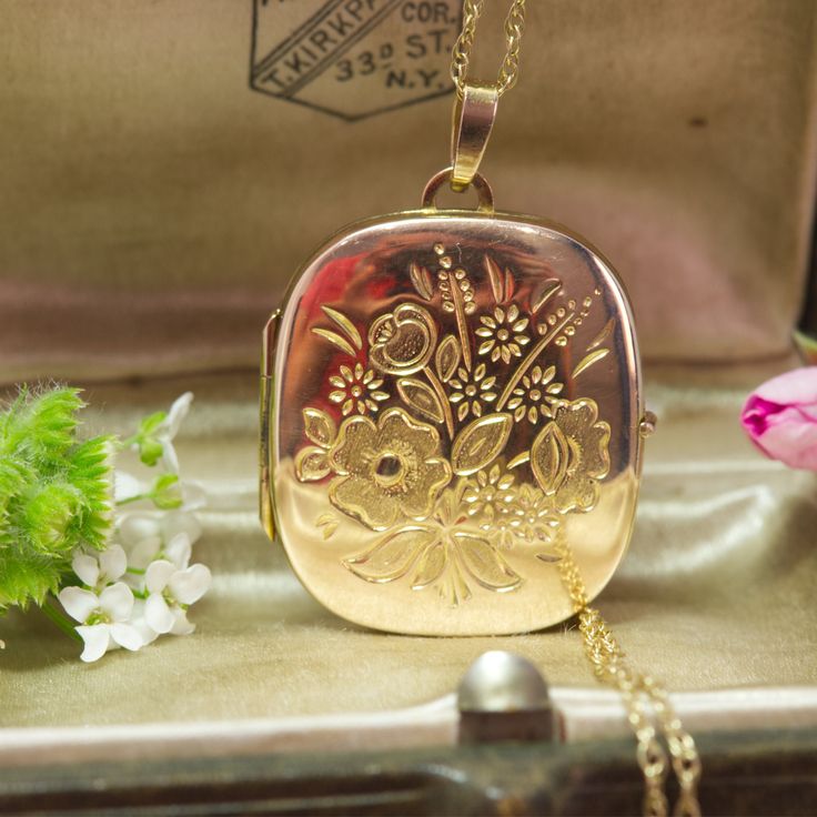 *Note* This locket is a full 9ct gold locket with a 9ct gold chain*  The difference between 9ct gold lockets and 9ct gold front and back lockets is: Full gold content: A "9ct gold locket" is entirely made of 9ct gold.  Partial gold content: A "9ct gold front and back locket" means only the front and back parts are 9ct gold, with other components being a different metal that has been gold plated. A stunning vintage 1992 9ct yellow gold large cushion shaped hinged locket with exquisite floral spra Athena Jewelry, Gold Lockets, Gold Fronts, Large Cushions, Gold Locket, Floral Spray, Plastic Sheets, Locket Necklace, Rope Chain