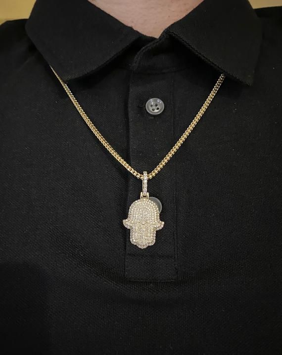 14k solid gold diamond Hamsa Pendant. Material: 14k solid Yellow Gold.Diamonds: 2.50 carats of round brilliant diamonds.Average quality used: VS2-SI1.Average diamond color used: F color.Gold weight: Approximately 9.5 grams.Length: Pendant is Approximately 1 inch long. With diamond bail 1.5 inches long. Width: 0.75 inches wide.Comes with Certificate of authentication.Comes in a nice box.Make it personal. Add a custom engraving to the back of this solid gold pendant. *Chain is sold separately. Mod Hand Set Diamond Pendant Necklaces, White Gold Cuban Link Diamond Necklace Gift, White Gold Diamond Necklace With Cuban Link, Cuban Link Jewelry With Pave Setting In Cubic Zirconia, Silver Diamond Cut Necklace Gold Plated, Cuban Link Cubic Zirconia Jewelry With Pave Setting, White Gold Cuban Link Jewelry With Pave Setting, Diamond White Cuban Link Necklace As Gift, Silver Necklace With Pave Setting In 14k Gold