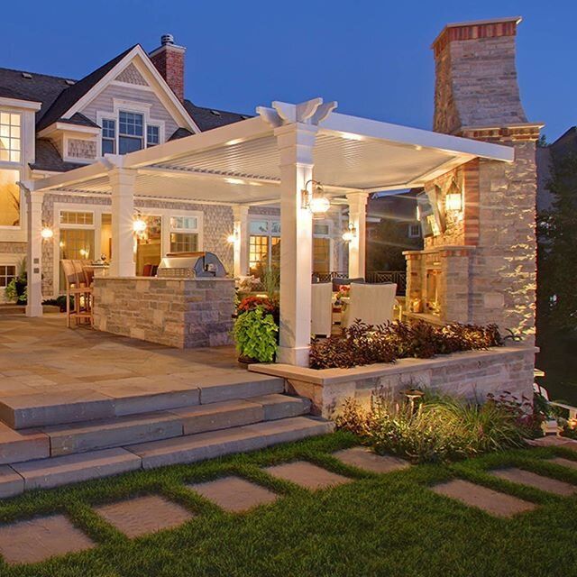 an outdoor patio with steps leading up to it and a pergolated area on the side