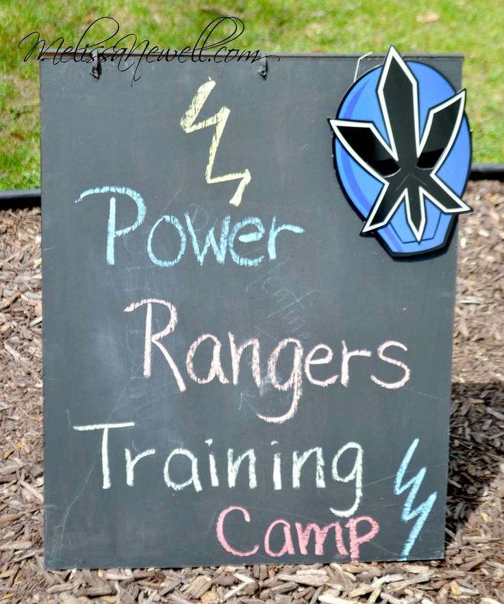 a sign with the words power rangers training camp written on it in front of some mulch