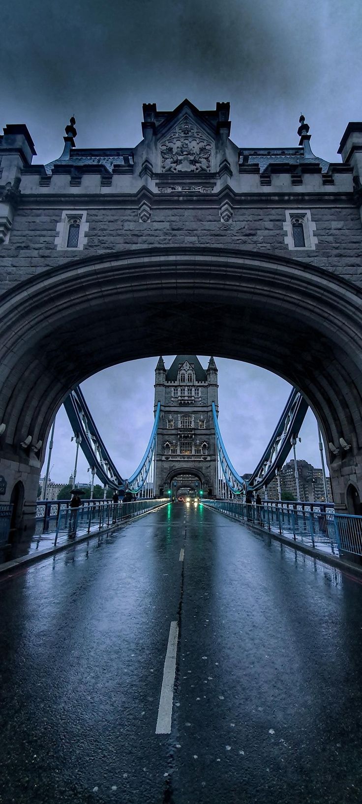 the tower bridge is lit up at night