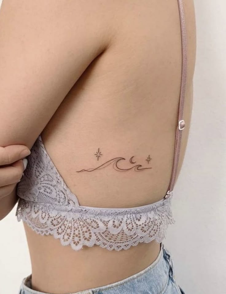 a woman with a tattoo on her stomach and the word love is written in cursive writing