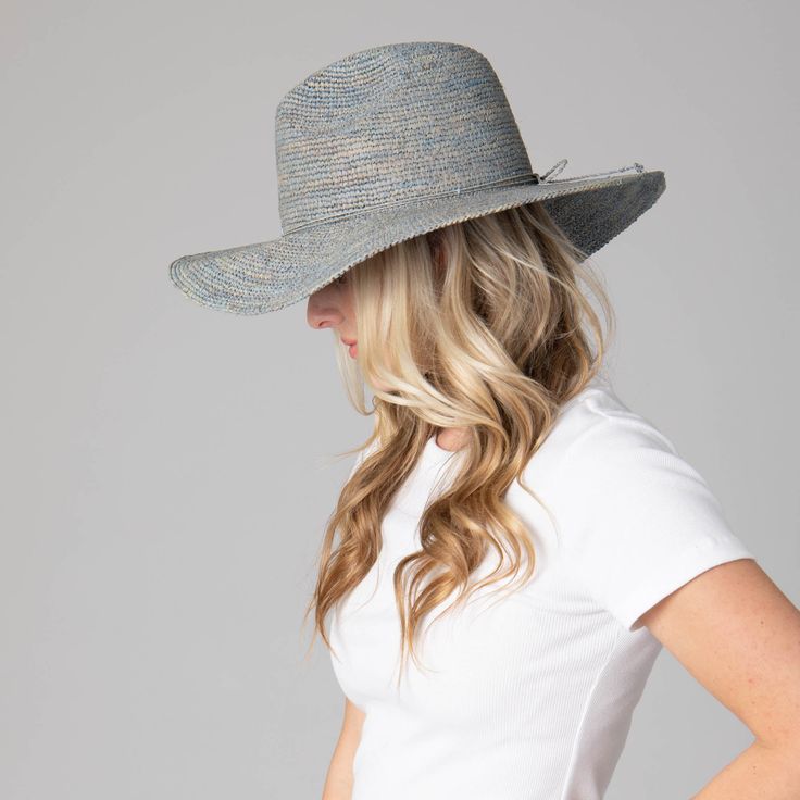 Be ready for any outdoor occasion in style with the Marina Women's Crochet Raffia Fedora. This exquisite fedora is crafted with 100% Crochet Raffia and features a 4" brim and adjustable size to fit perfectly. Choose between a brown, blue, or natural hue with the unique addition of twisted cording and bow in the center back. Elevate your ensemble and be the talk of the town in this one of a kind fedora. Features: Colors: Brown, Blue, & NaturalMaterials: 100% Crochet RaffiaBrim Size: 4" BrimSize: Blue Curved Brim Sun Hat For Rodeo, Blue Brimmed Straw Hat For Rodeo, Blue Western Straw Hat With Curved Brim, Casual Blue Wide Brim Fedora, Western Blue Wide Brim Sun Hat, Blue Western Hat For Vacation, Casual Blue Fedora With Wide Brim, Western Style Blue Straw Hat For Summer, Western Blue Straw Hat For Summer