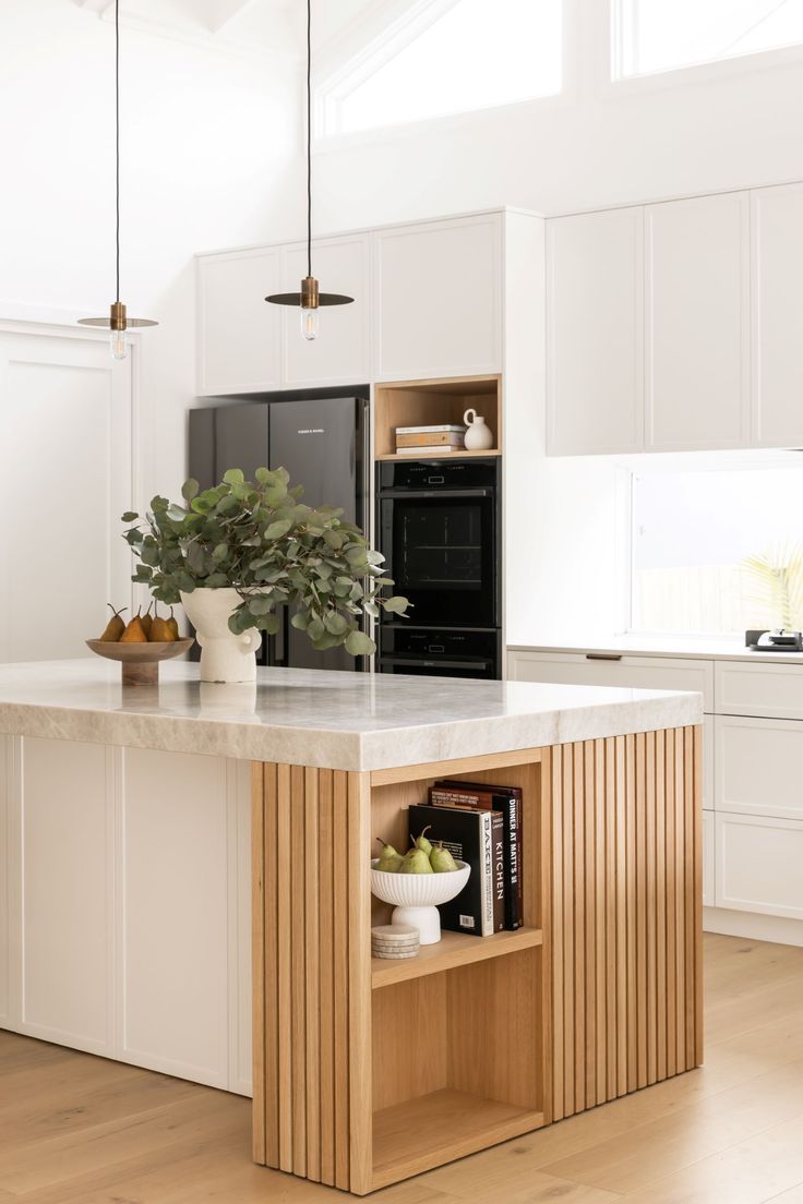 a kitchen with white cabinets and an island