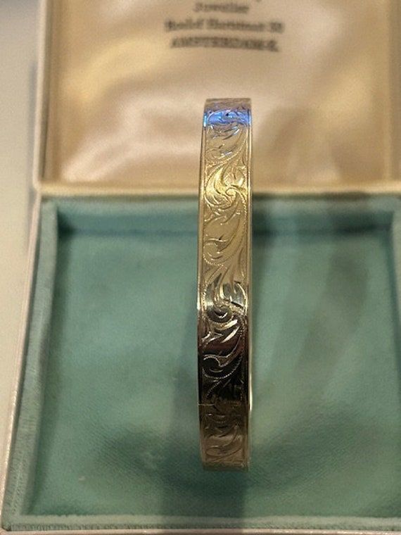 This a very beautiful engraved bangle bracelet Made of 14k gold  With all hallmarks to veryfy the gold contents. Makers mark included along wit the 585 mark for 14k gold. Vintage Dutch piece of jewellery with the Dutch assay mark and makers mark. 7cm in inner diameter, it will fit small or medium ladies wrist! Beautiful outer engraving of flowers and leaves, please see photos. Apr..15gr of gold. Beautiful Continental piece of fine jewellery with no dents, scuffs etc. 14k Gold Bangle Bracelet, Engraved Bangle Bracelet, Engraved Bangle, Gold Bangle Bracelet, Gold Bangle, Fine Jewellery, Gold Bangles, Makers Mark, Bangle Bracelet