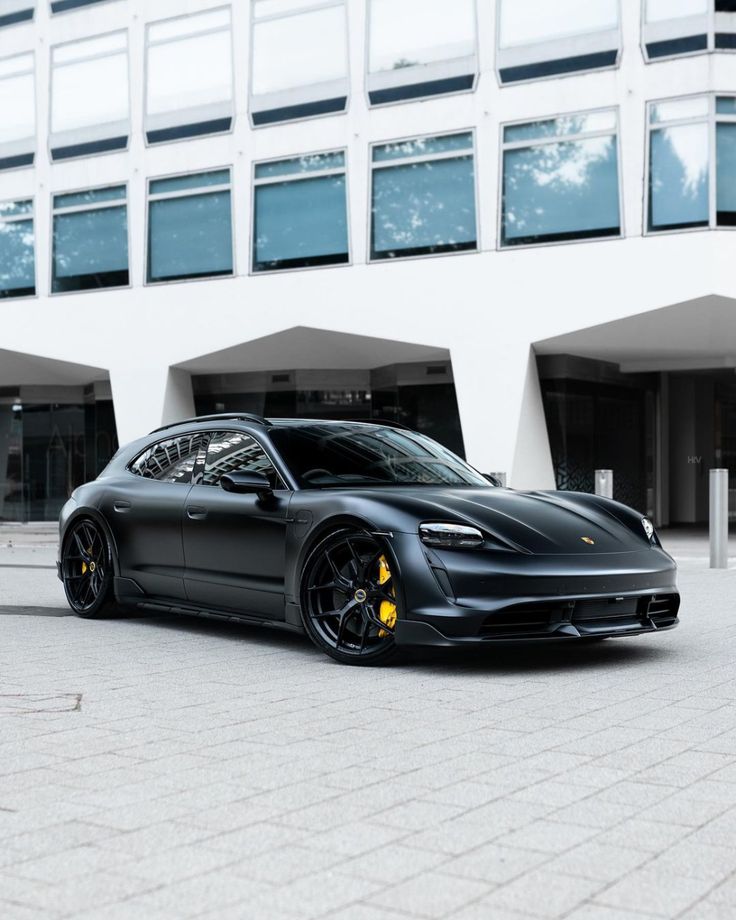 a black sports car parked in front of a building