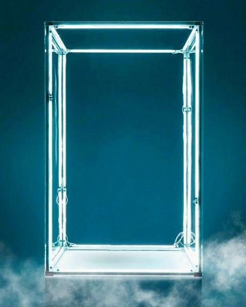 an illuminated square frame in the middle of some clouds with blue sky and white clouds behind it