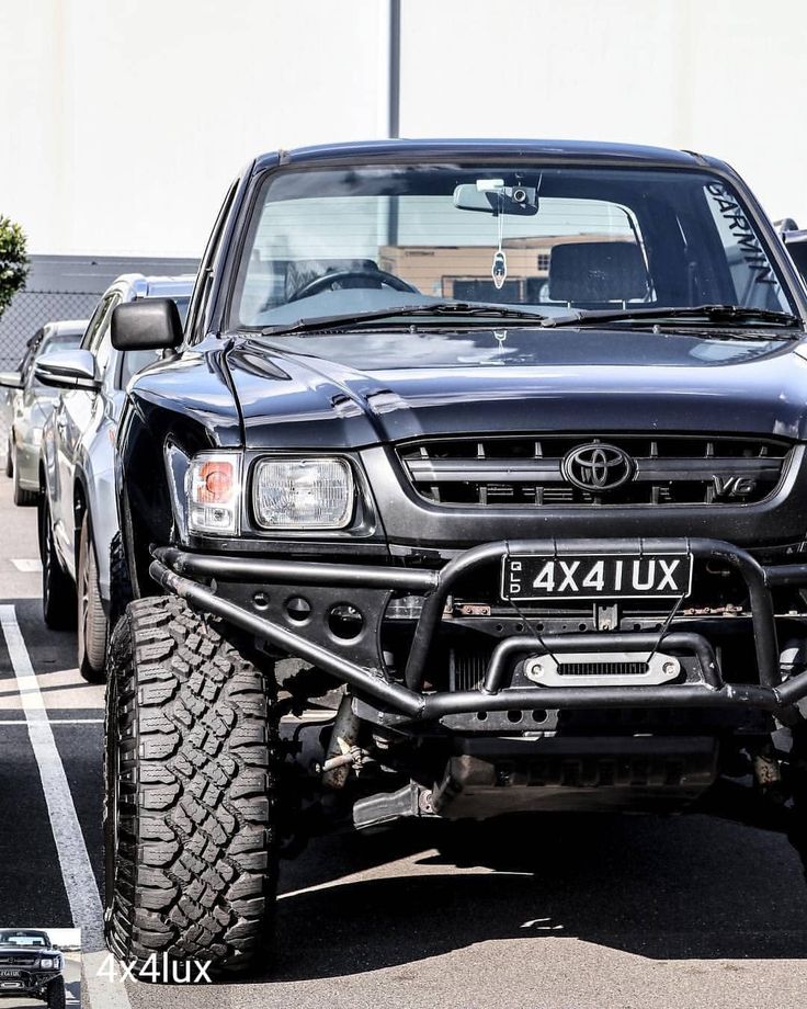 a black truck parked in a parking lot